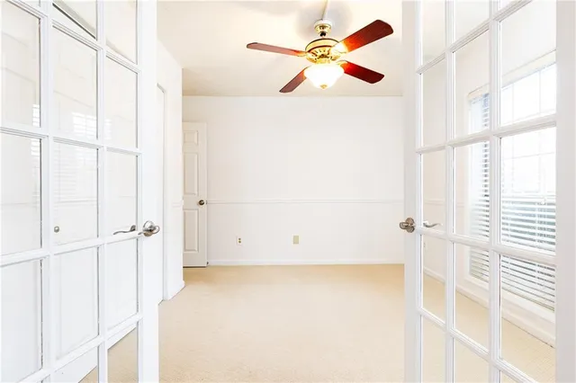 a white kitchen with granite countertop stainless steel appliances