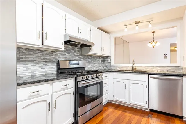 a kitchen with stainless steel appliances a refrigerator stove and sink