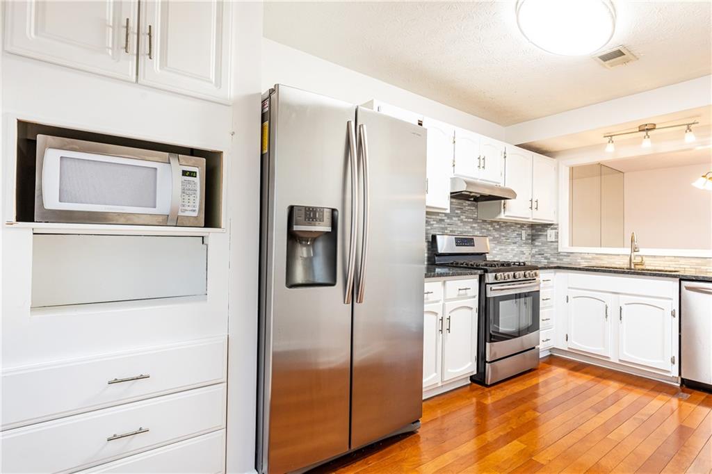 2901 Lenox Way Northeast, Unit 902 Atlanta, GA 30324 - Photo 33 of 34 a kitchen with stainless steel appliances a refrigerator stove and sink