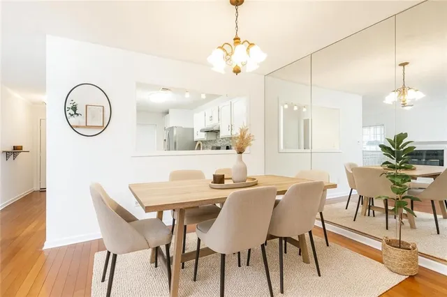 a view of a a dining table chairs and chandelier
