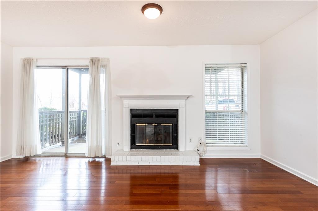 2901 Lenox Way Northeast, Unit 902 Atlanta, GA 30324 - Photo 7 of 34 a view of an empty room with wooden floor and a window