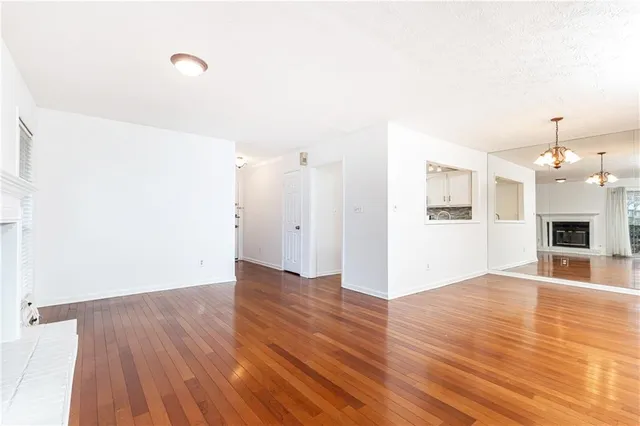 a view of a room with wooden floor and a ceiling fan