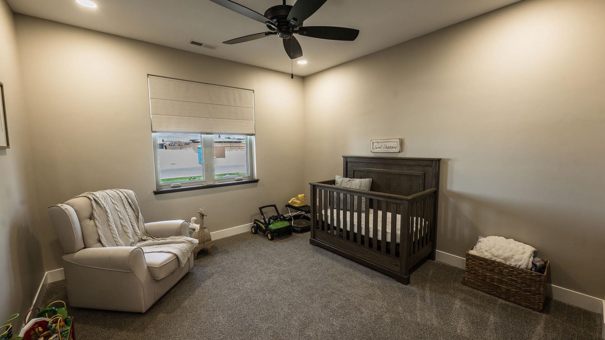 2639 Emerald Ridge Lane Grand Junction, CO 81506 - Photo 24 of 42 a bedroom with furniture and a window