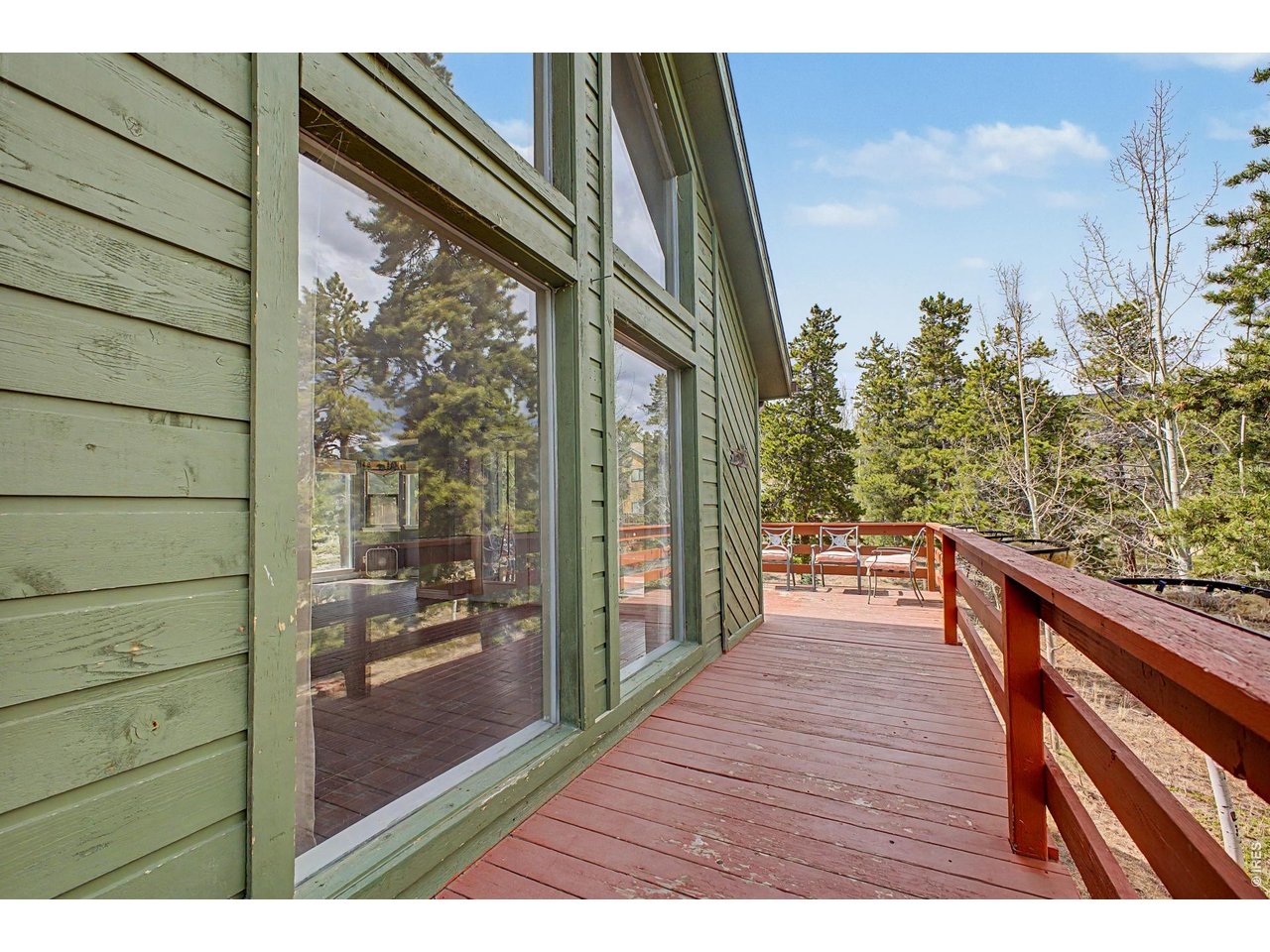 76 Highlands Drive Bailey, CO 80421 - Photo 4 of 49 a balcony with wooden floor and bench