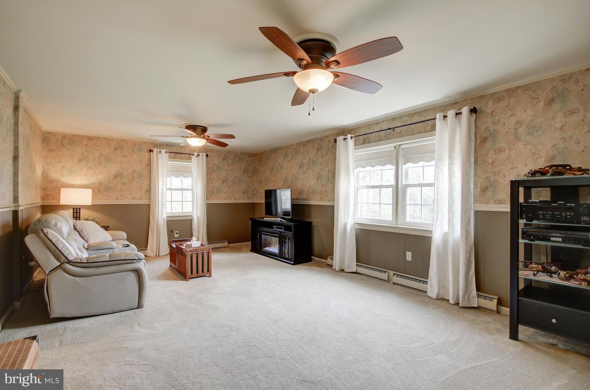 6588 Kelly Road Warrenton, VA 20187 - Photo 27 of 39 Family Room with Ceiling Fan and three windows