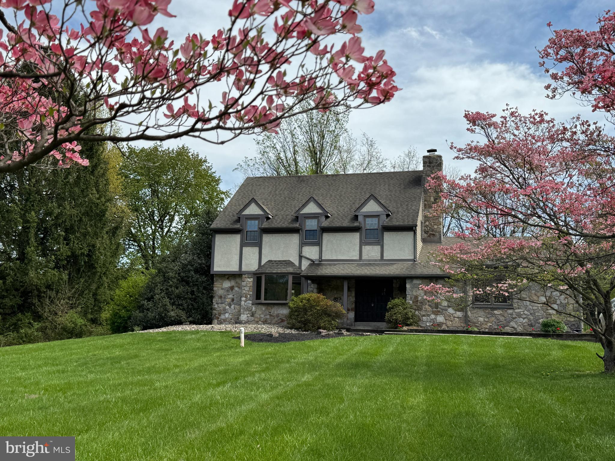 a front view of a house with a garden