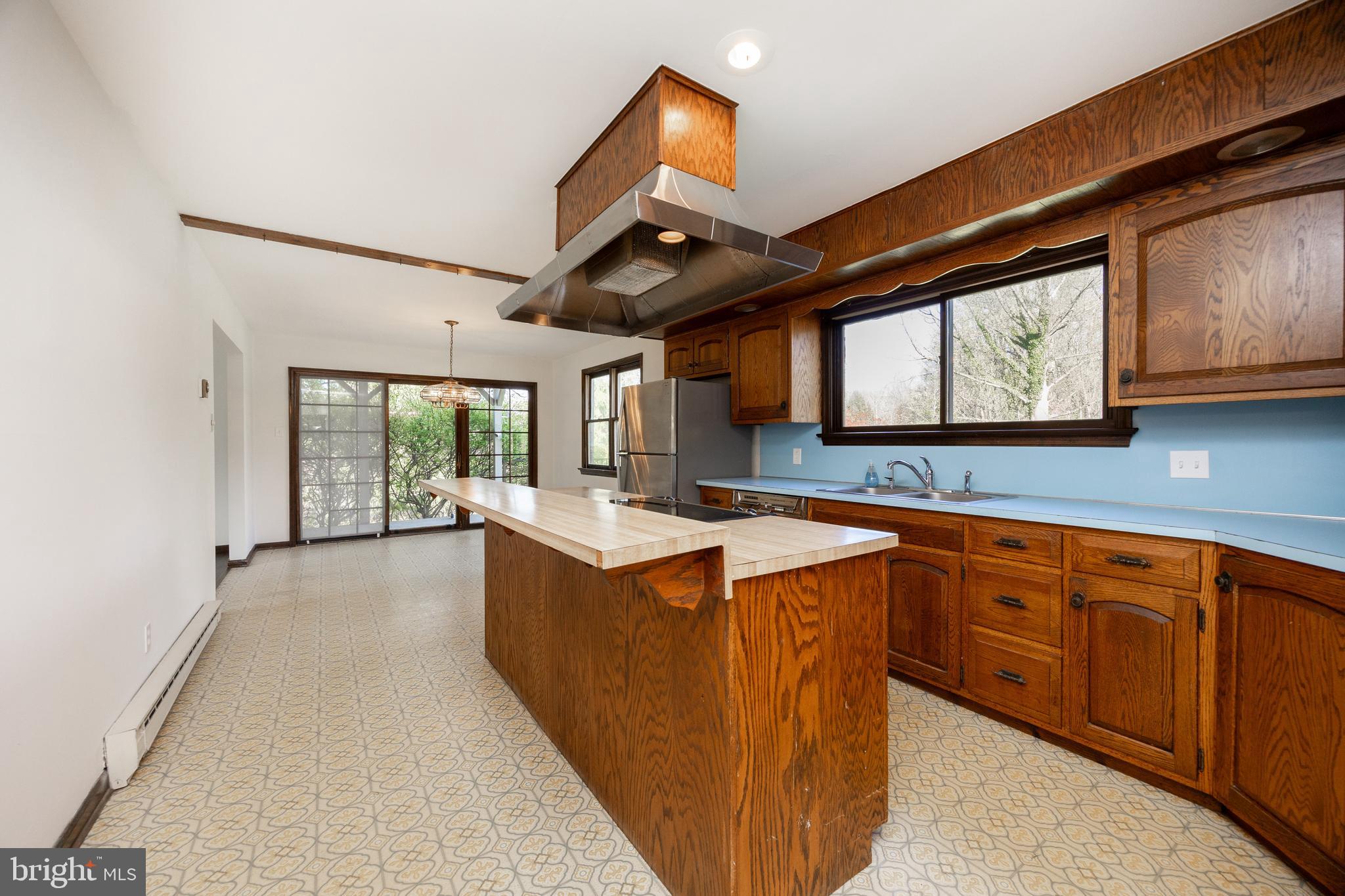 800 Scholl Road Pottstown, PA 19465 - Photo 12 of 49 a large kitchen with stainless steel appliances granite countertop sink stove and wooden cabinets