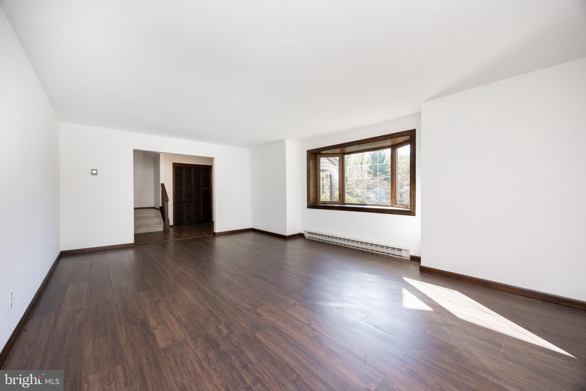 800 Scholl Road Pottstown, PA 19465 - Photo 18 of 49 an empty room with wooden floor and windows