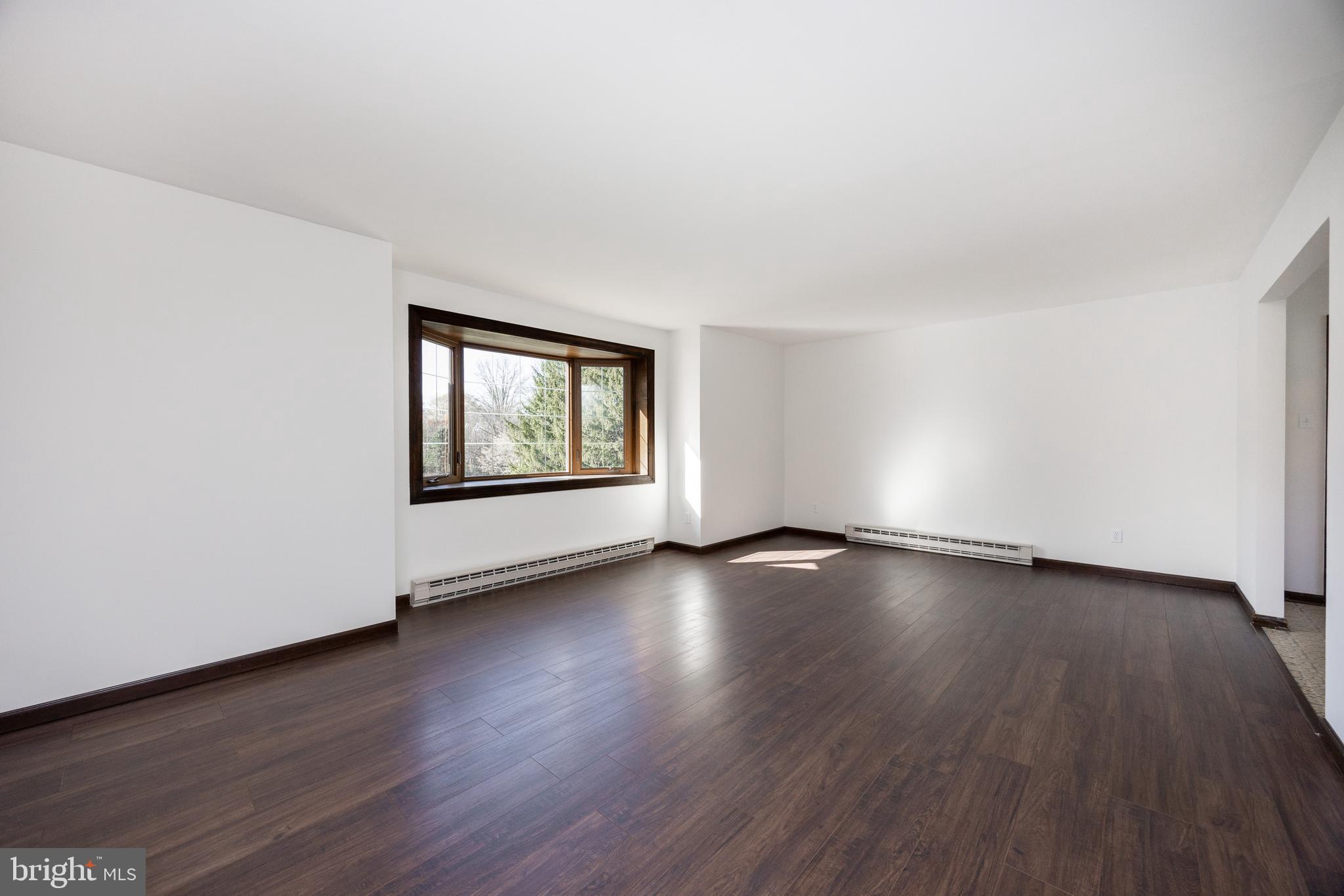800 Scholl Road Pottstown, PA 19465 - Photo 19 of 49 an empty room with wooden floor and windows