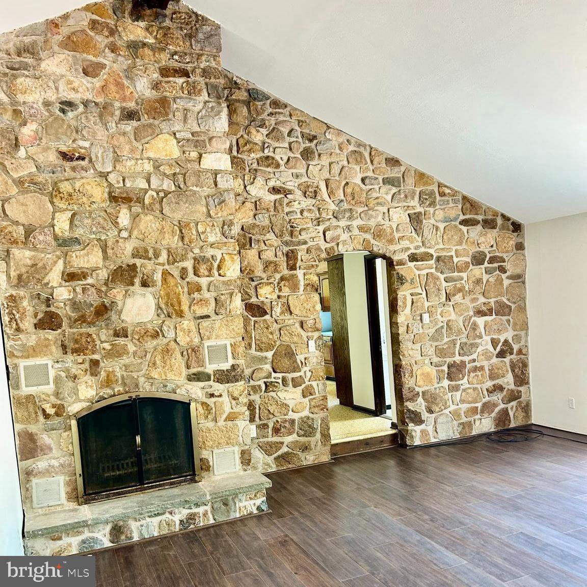 800 Scholl Road Pottstown, PA 19465 - Photo 23 of 49 an empty room with wooden floor and a fireplace