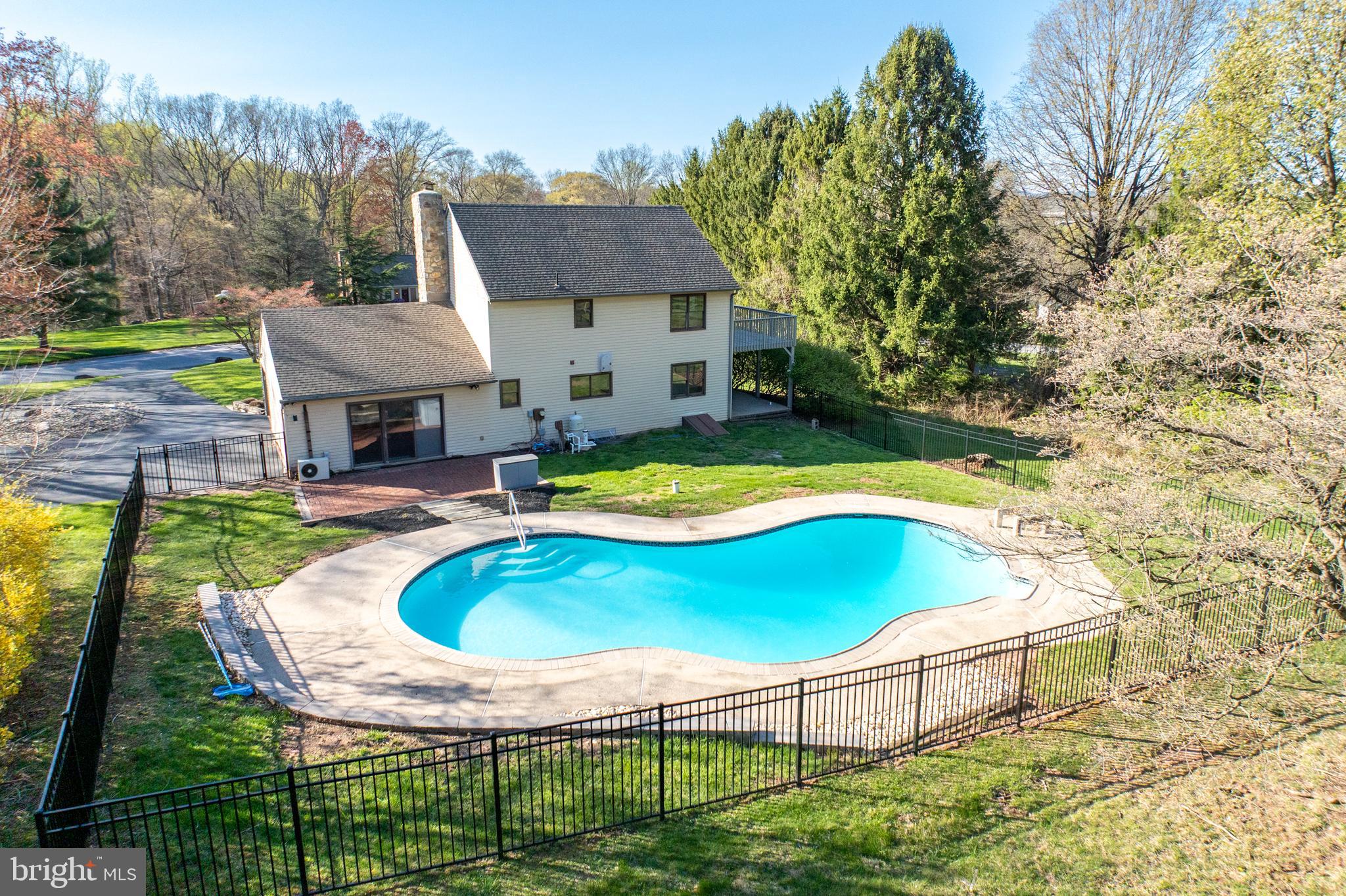 800 Scholl Road Pottstown, PA 19465 - Photo 9 of 49 a swimming pool with outdoor seating and yard
