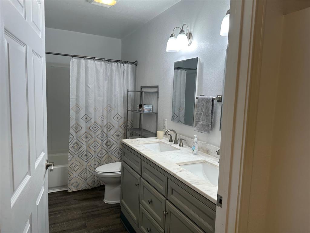 144 Huntoon Trail Mabank, TX 75156 - Photo 5 of 8 a bathroom with a double vanity sink toilet and shower