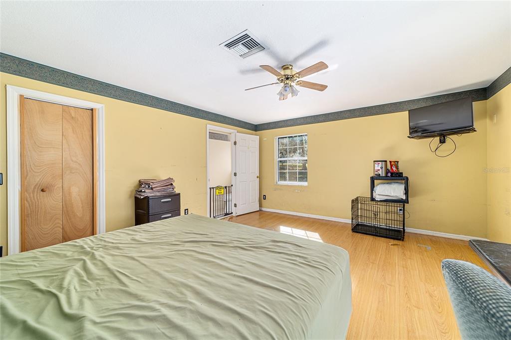 4350 Southwest 89th Avenue Ocala, FL 34481 - Photo 41 of 90 a bedroom with a bed and wooden floor