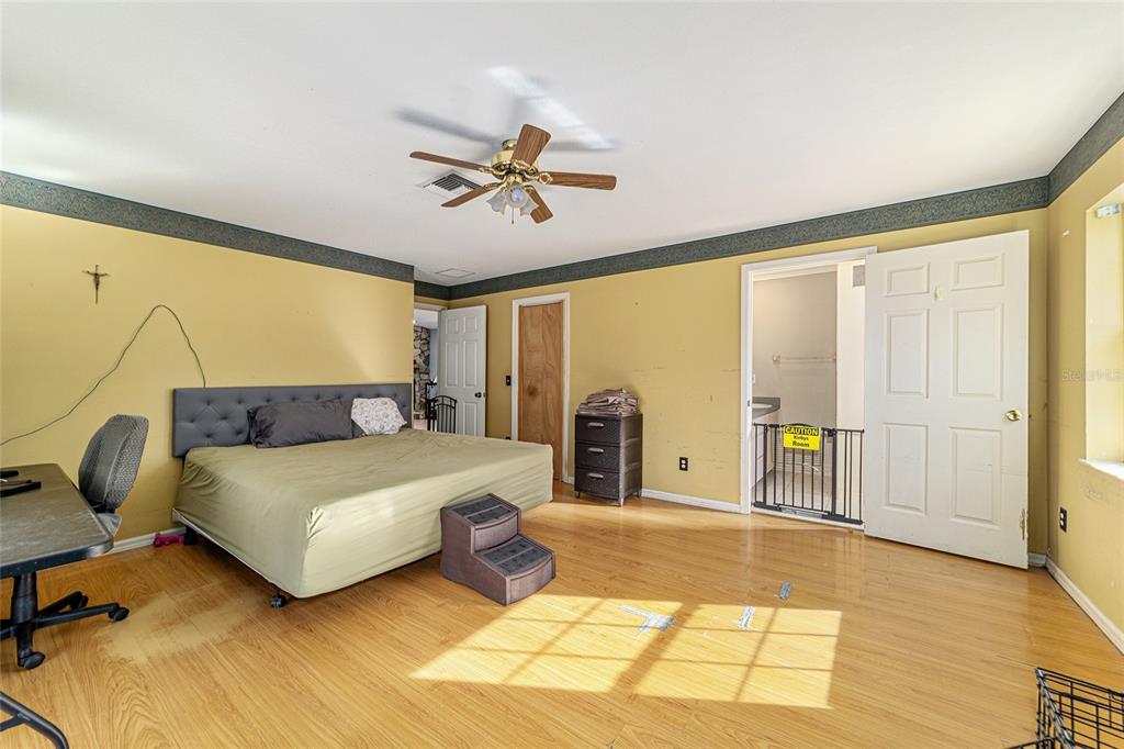 4350 Southwest 89th Avenue Ocala, FL 34481 - Photo 42 of 90 a spacious bedroom with a bed and ceiling fan