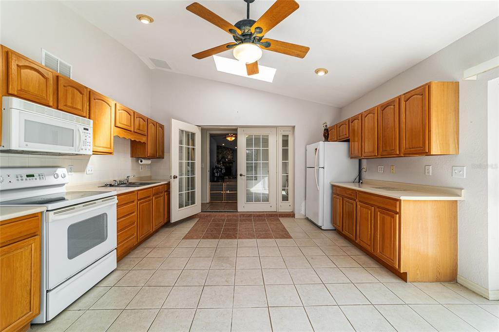 4350 Southwest 89th Avenue Ocala, FL 34481 - Photo 57 of 90 a large kitchen with stainless steel appliances granite countertop a stove sink and cabinets