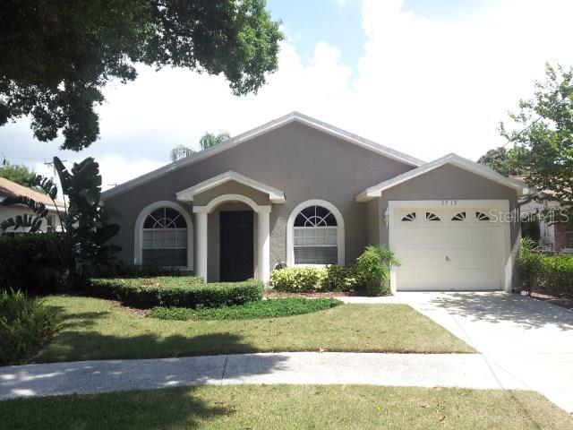 2719 West Arch Street Tampa, FL 33607 - Photo 1 of 1 a front view of a house with a yard and garage
