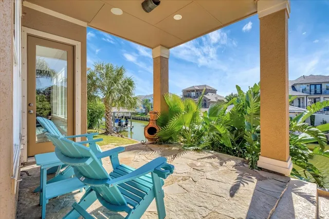 a view of a porch with furniture and a yard