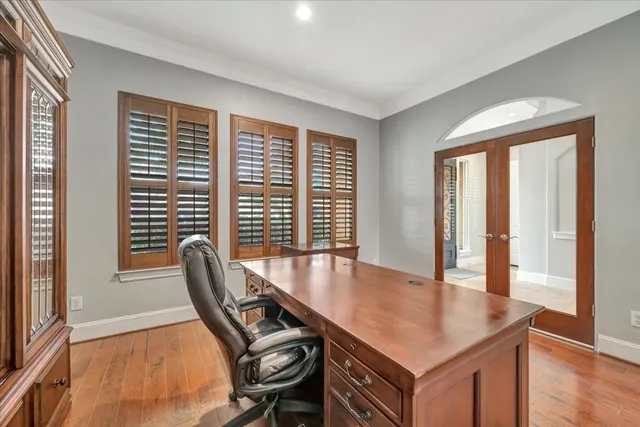 a view of a workspace with furniture and wooden floor