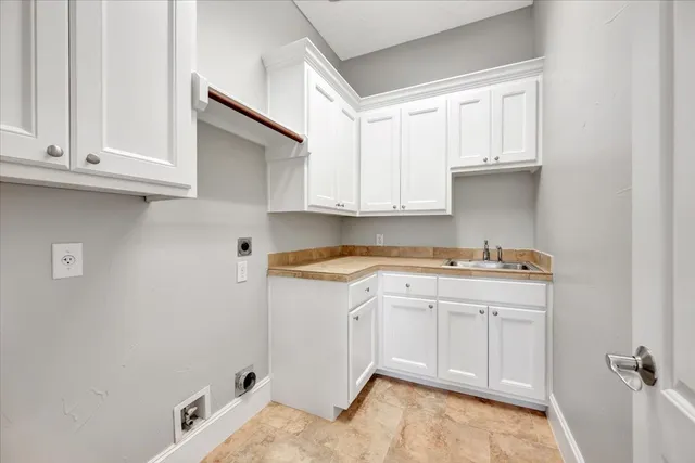 a kitchen with cabinets appliances and a sink