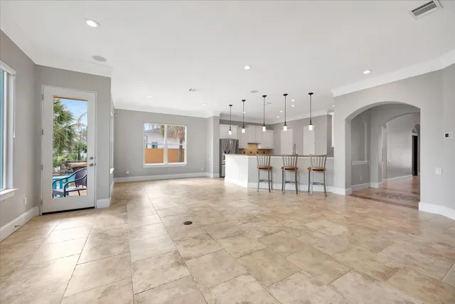 a view of a livingroom with a fireplace cabinet and windows