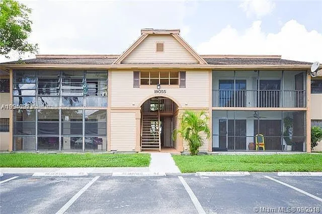 a front view of a house with a garden and plants