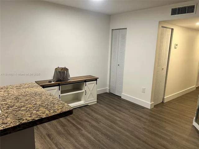 a living room with a couch and wooden floor