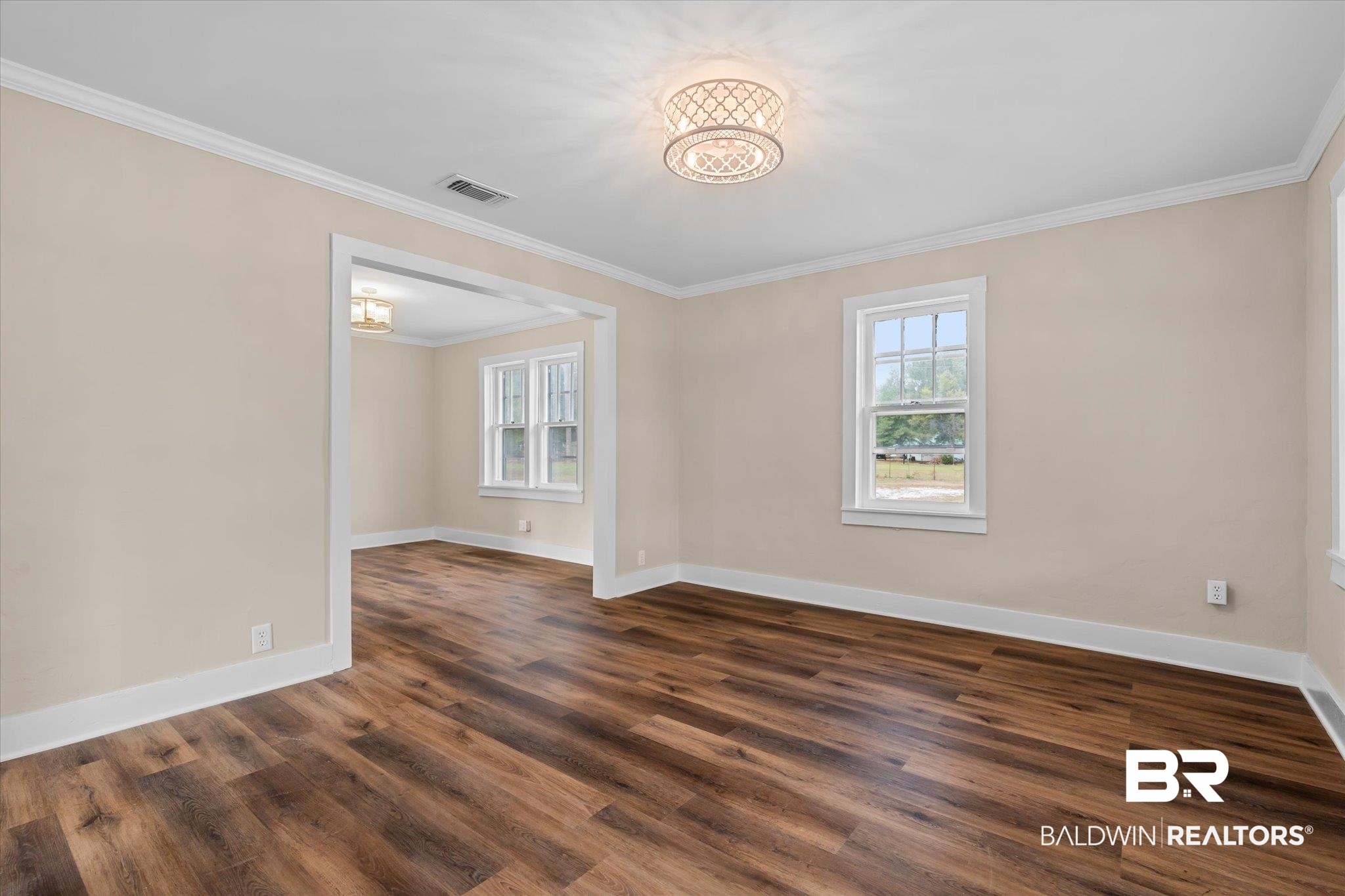 4630 General Road Mobile, AL 36619 - Photo 4 of 33 Unfurnished room with dark hardwood / wood-style floors, an inviting chandelier, and ornamental molding