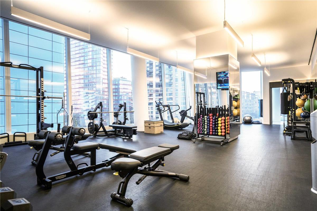 50 West Street, Unit 18C Manhattan, NY 10006 - Photo 13 of 23 a view of a room with gym equipment