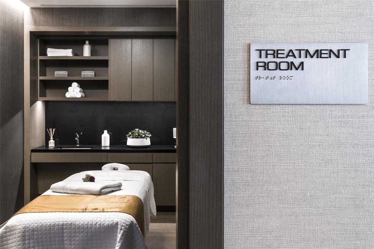 50 West Street, Unit 18C Manhattan, NY 10006 - Photo 18 of 23 a bed with a black white bedspread and pillows