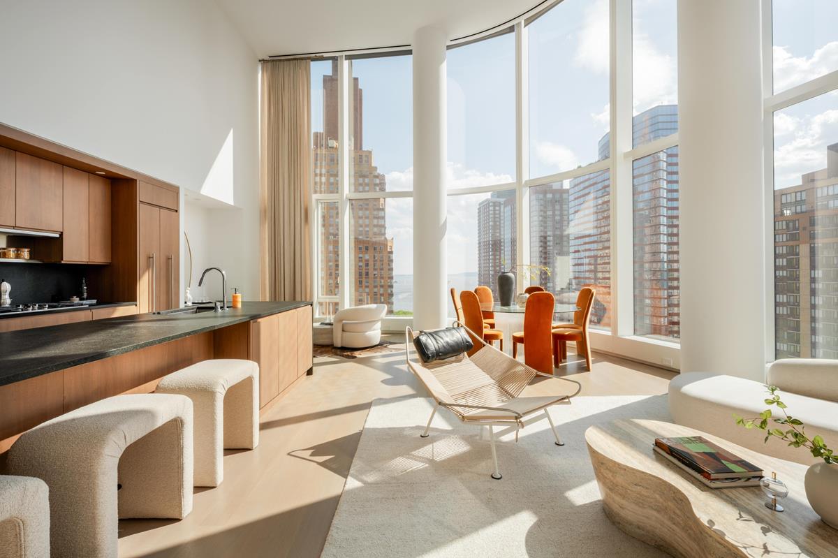 50 West Street, Unit 18C Manhattan, NY 10006 - Photo 3 of 23 a living room with furniture and floor to ceiling windows