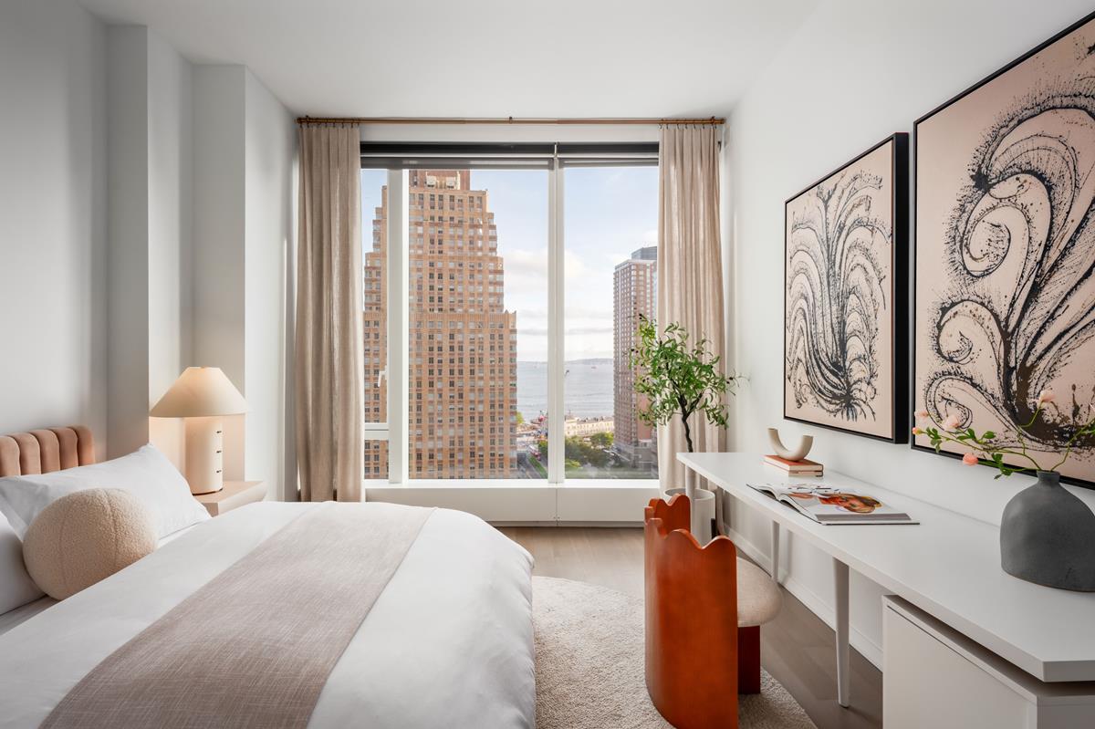 50 West Street, Unit 18C Manhattan, NY 10006 - Photo 8 of 23 a bedroom with a bed and a large window with the outer view