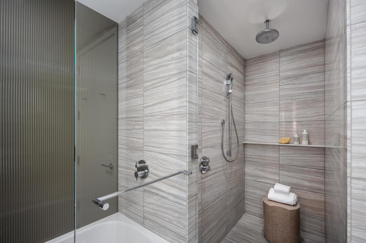 50 West Street, Unit 18C Manhattan, NY 10006 - Photo 9 of 23 a bathroom with a toilet and a shower