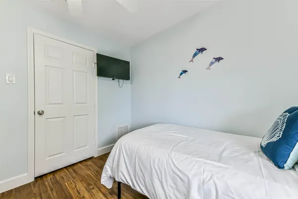 a bedroom with a bed and flat screen tv