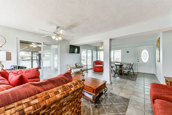 a living room with furniture a dining table and chairs with outer view