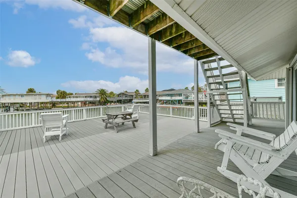 a view of roof deck with seating space and wooden floor
