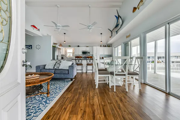 a living room with lots of wooden furniture and wooden floor