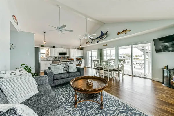 a living room with furniture a rug and a floor to ceiling window