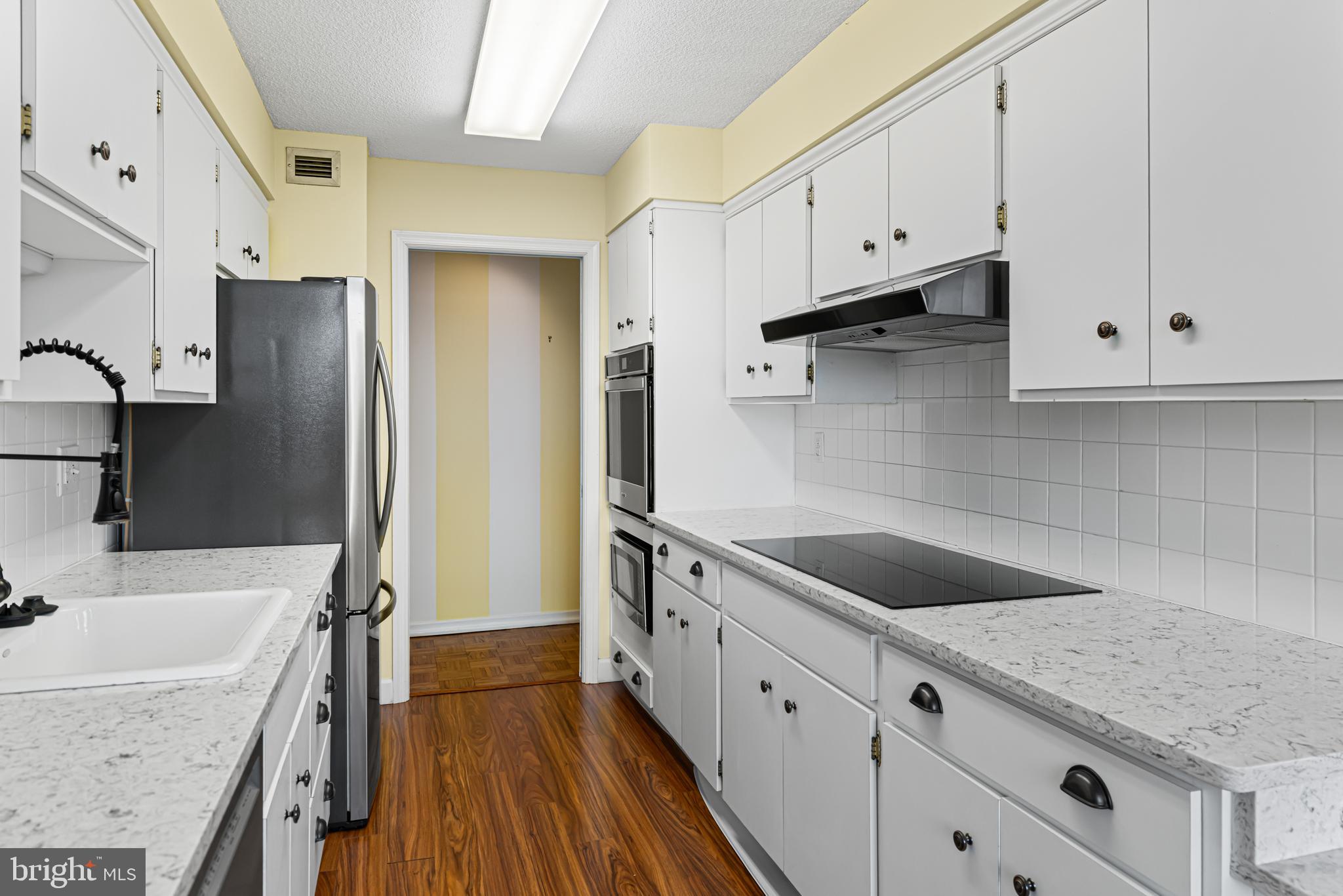 8302 Old York Road, Unit B42 Elkins Park, PA 19027 - Photo 17 of 42 a kitchen with granite countertop a sink stove and refrigerator