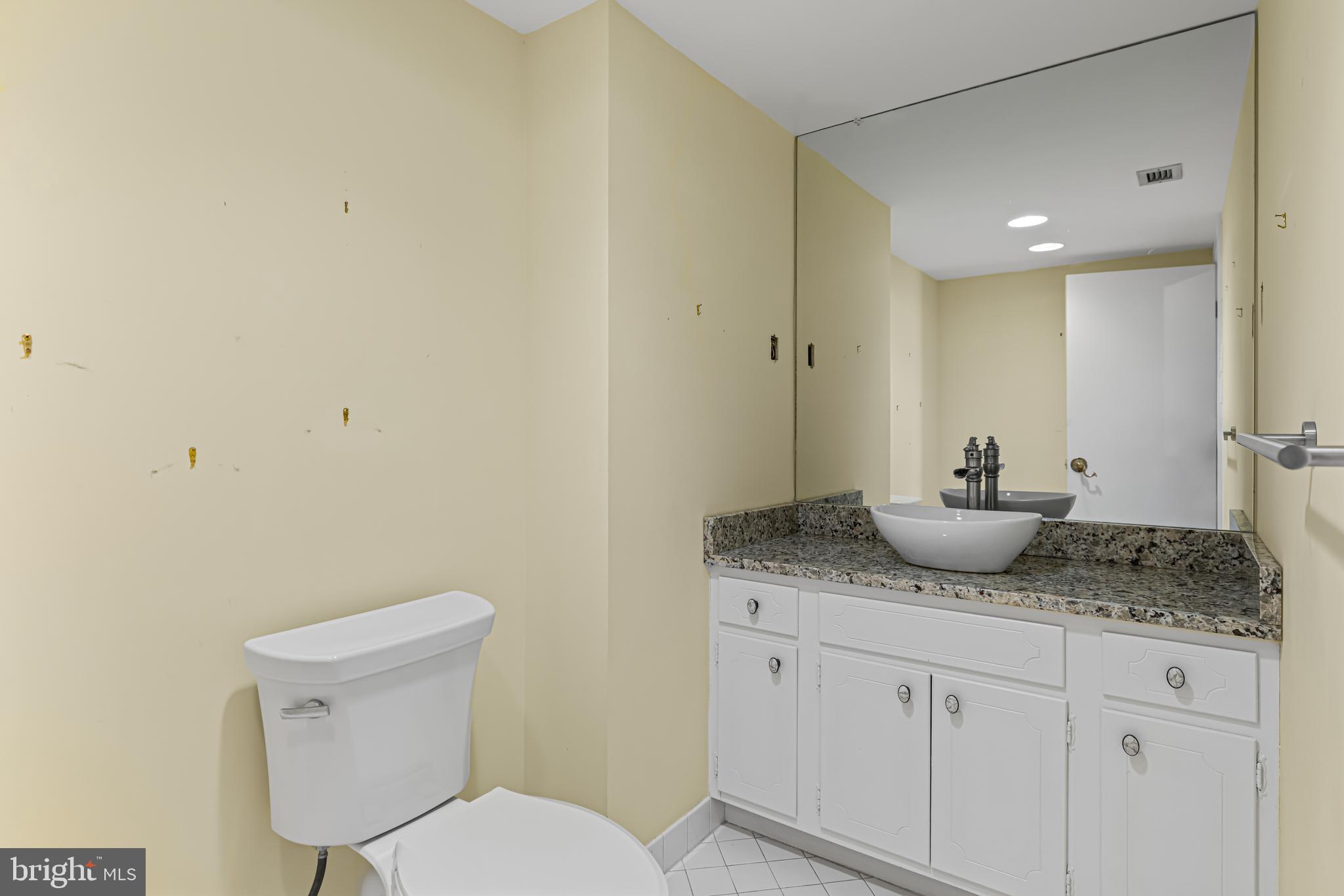 8302 Old York Road, Unit B42 Elkins Park, PA 19027 - Photo 25 of 42 a bathroom with a granite countertop sink and a toilet