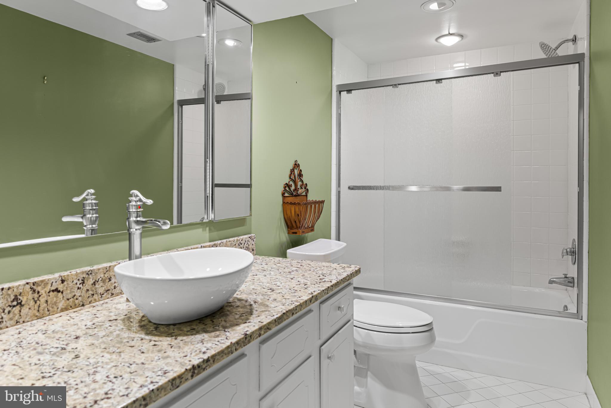 8302 Old York Road, Unit B42 Elkins Park, PA 19027 - Photo 35 of 42 a bathroom with a granite countertop sink toilet and shower