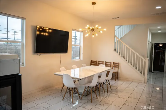 a view of a dining room with furniture and a flat screen tv