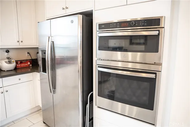 a kitchen with cabinets and stainless steel appliances