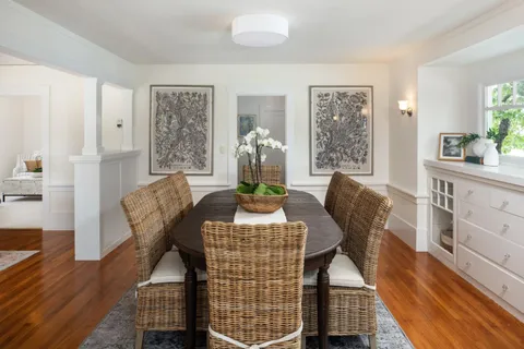 a view of a dining room with furniture window and wooden floor