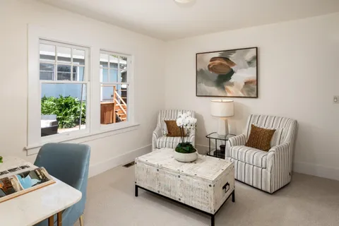 a living room with furniture and flowers