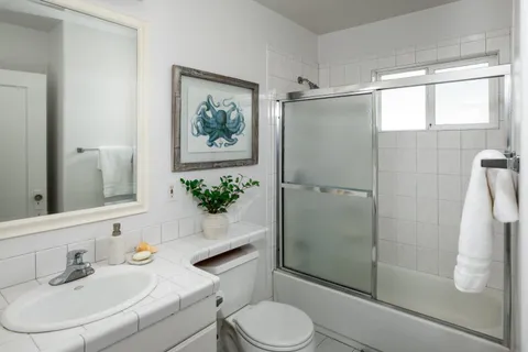 a bathroom with a toilet sink and shower