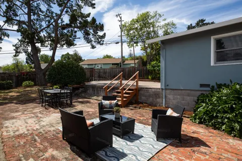a view of a backyard with sitting area