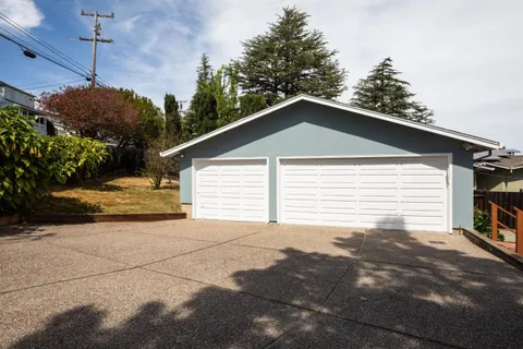 a view of a house with a yard and garage