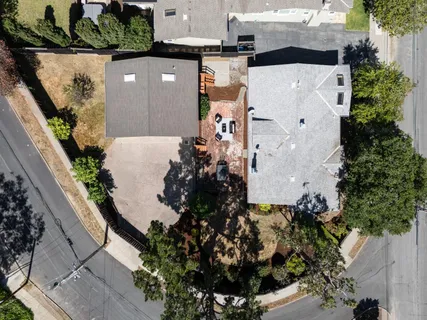 an aerial view of a house with a yard