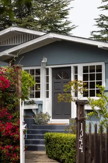 a front view of a house with a garden