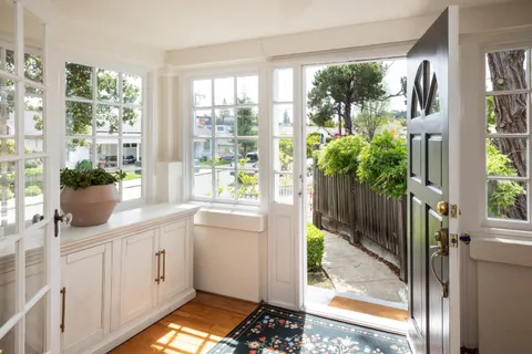 a kitchen with a large window and front door